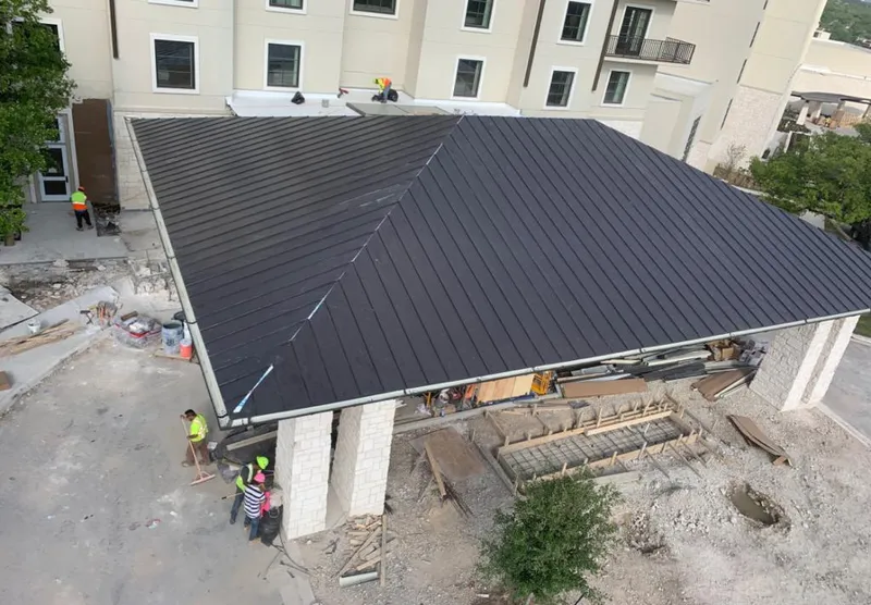 Metal roofing installation team working on a commercial building in Grayson Valley